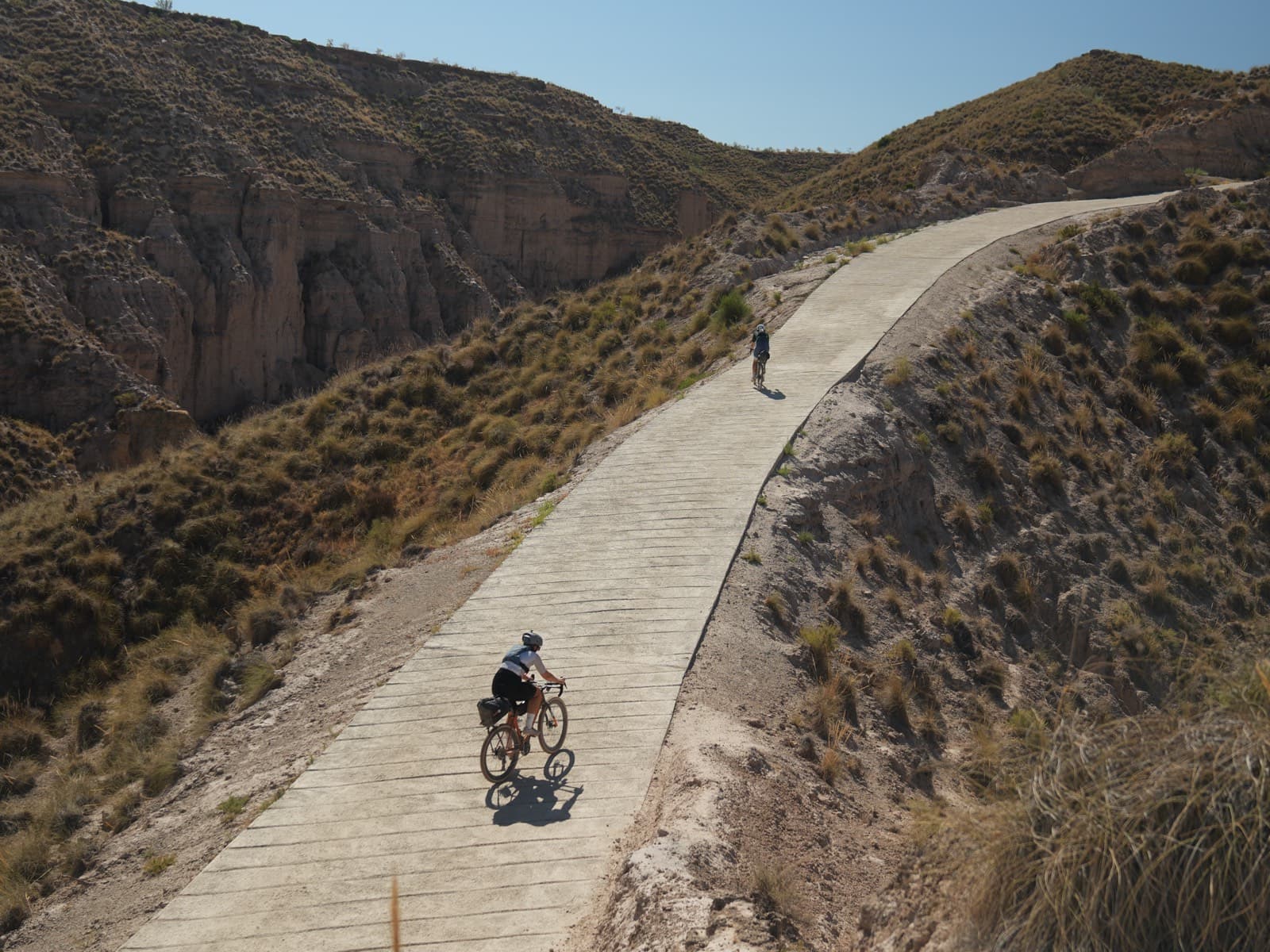 Riders on an epic climb through canyon terrain